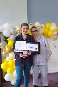 Mary-Lee Cameron holding awards